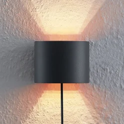 Arcchio wandlamp Zuzana, rond, zwart, stekker, 13 cm