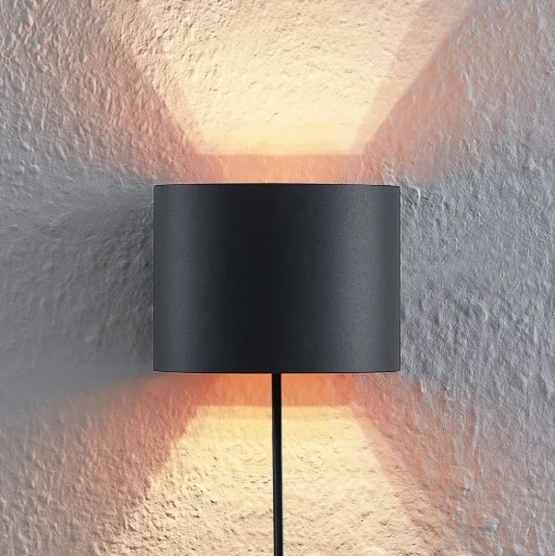 Arcchio wandlamp Zuzana, rond, zwart, stekker, 13 cm