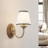 Lindby wandlamp Lumiel, crème/messing, textiel, 27cm